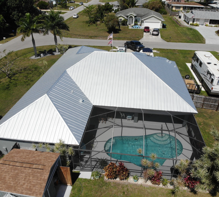 White metal roof installation over a screened pool enclosure